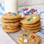 M&M cookies stacked with milk