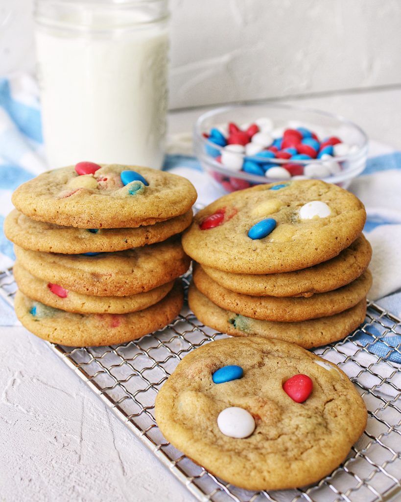 M&M cookies stacked with milk