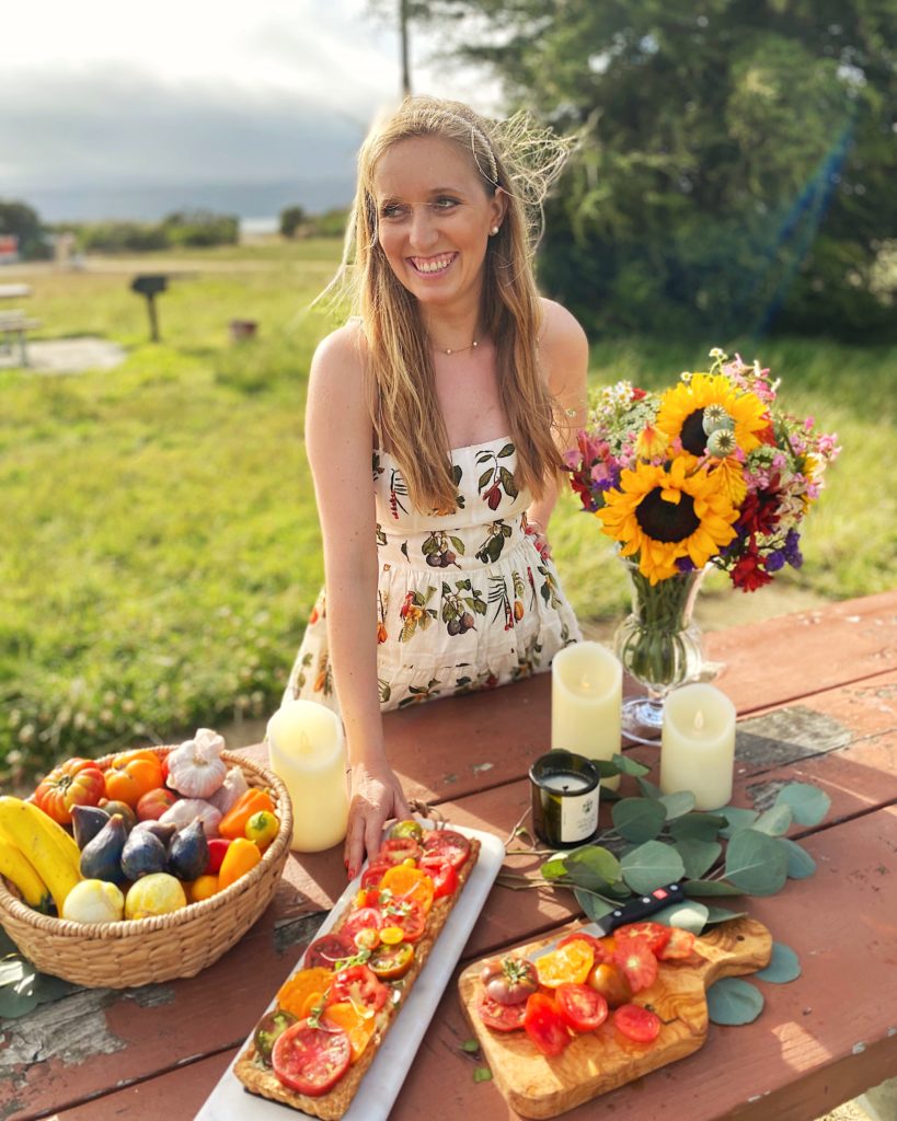 Woman holding tomato tart outside