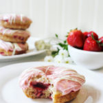 Strawberry donuts, pink frosting, bowl of strawberries