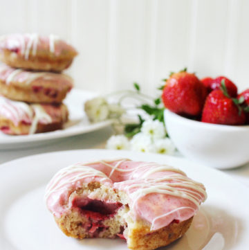 Strawberry donuts, pink frosting, bowl of strawberries