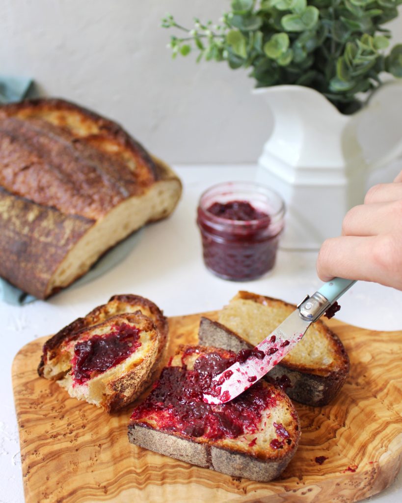 Spreading jam on homemade toast