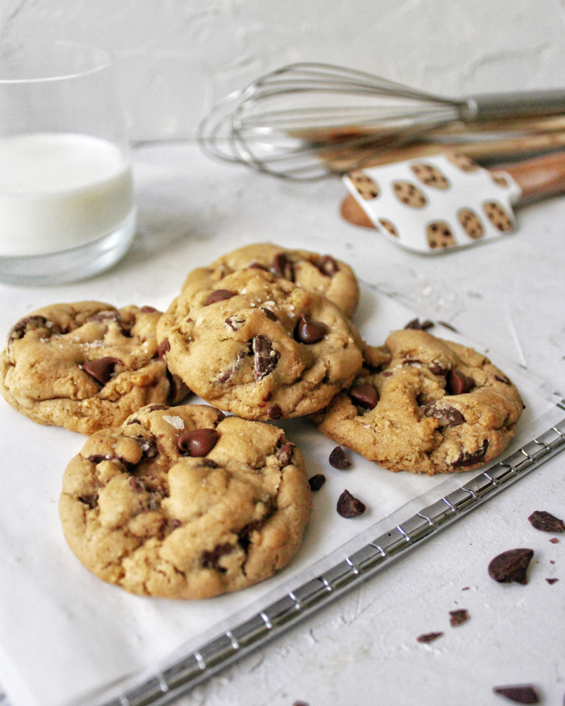 chocolate chip cookies on a cooling rack with milk