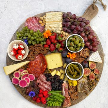 Charcuterie board with cheeses, meats, veggies, fruits