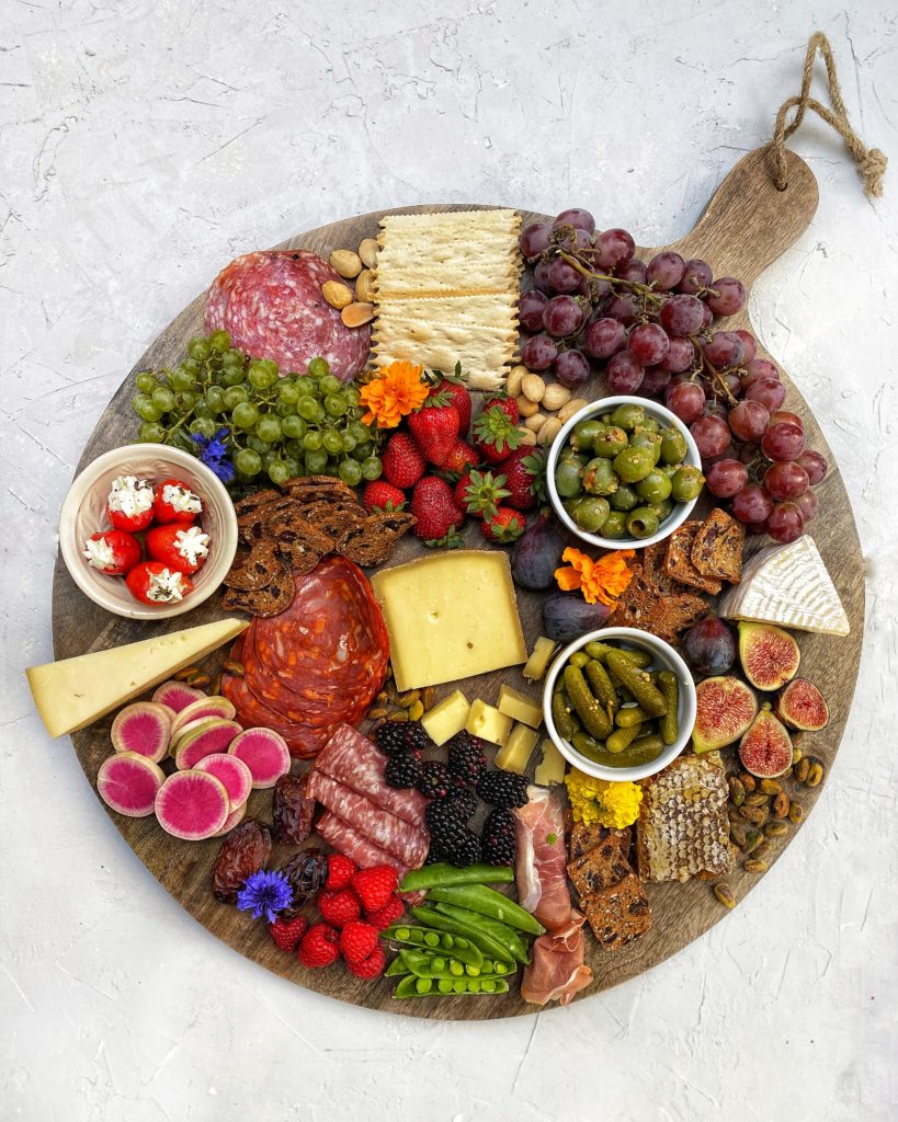 Charcuterie board with cheeses, meats, veggies, fruits