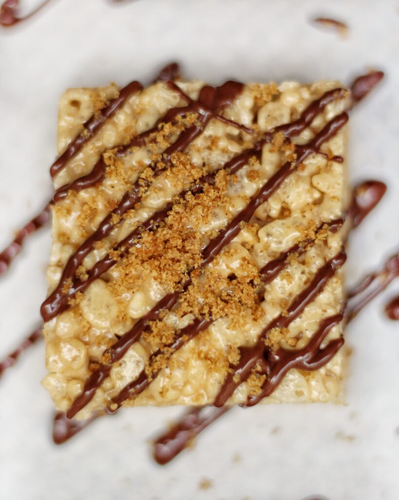 One square of s'mores Rice Krispie Treats with chocolate drizzle 