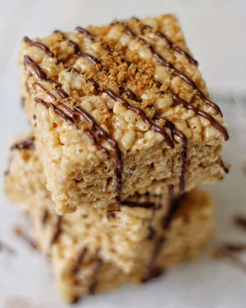Stack of S'mores Rice Krispie Treats with chocolate drizzle 