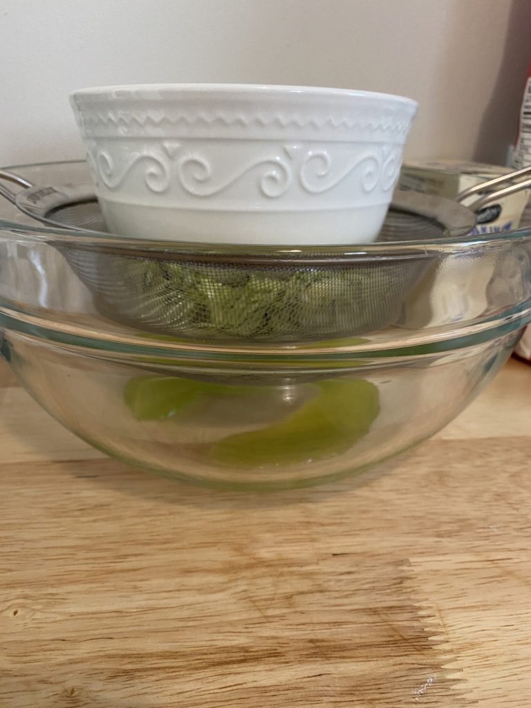 Draining zucchini over a bowl