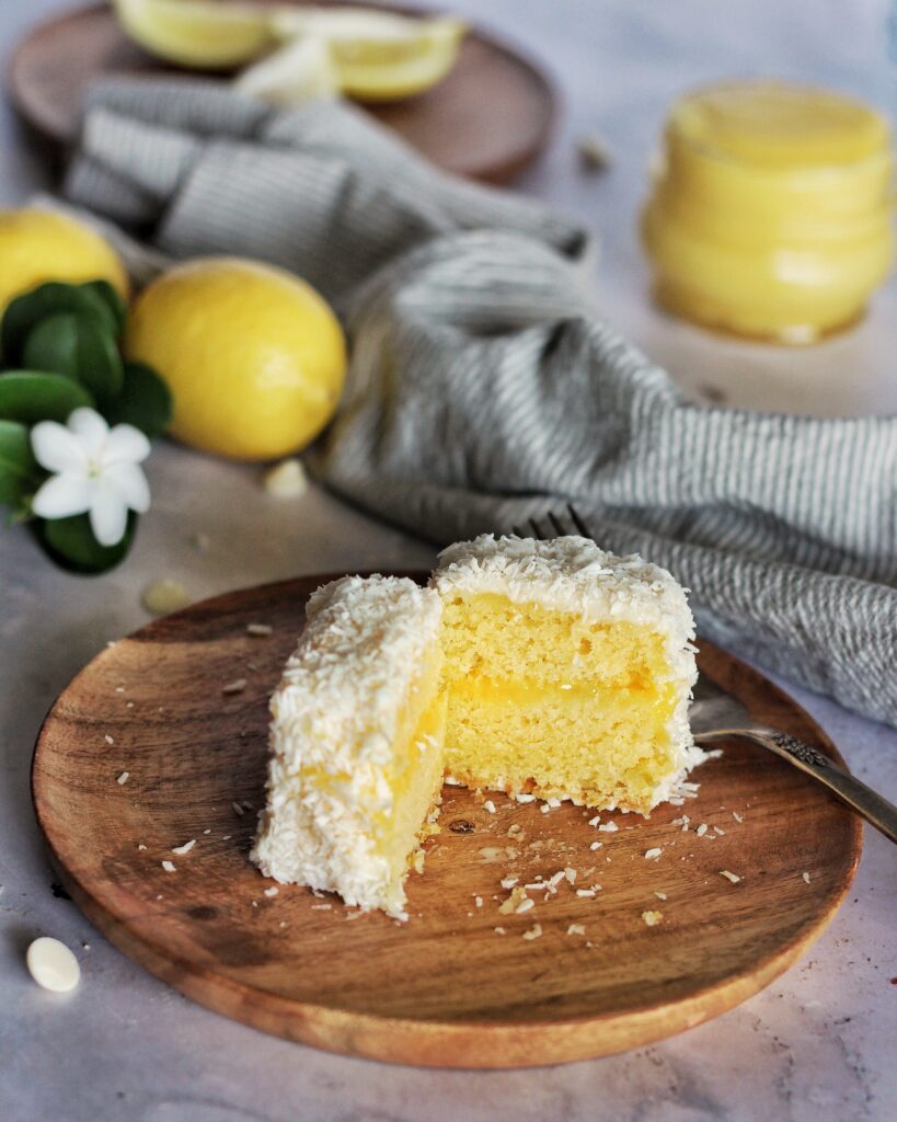 Lemon white chocolate lamington on a wooden plate 