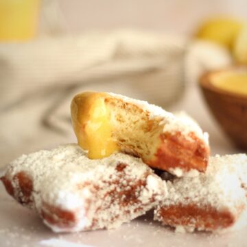 taking a bite of a beignet