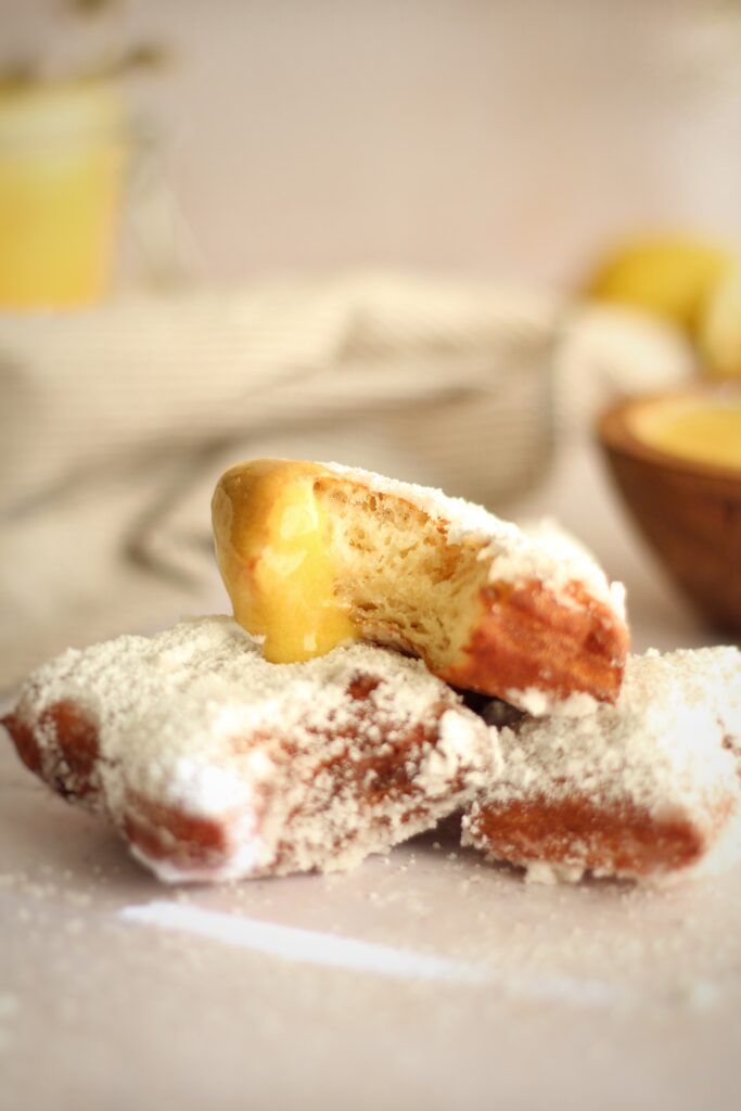 taking a bite of a beignet