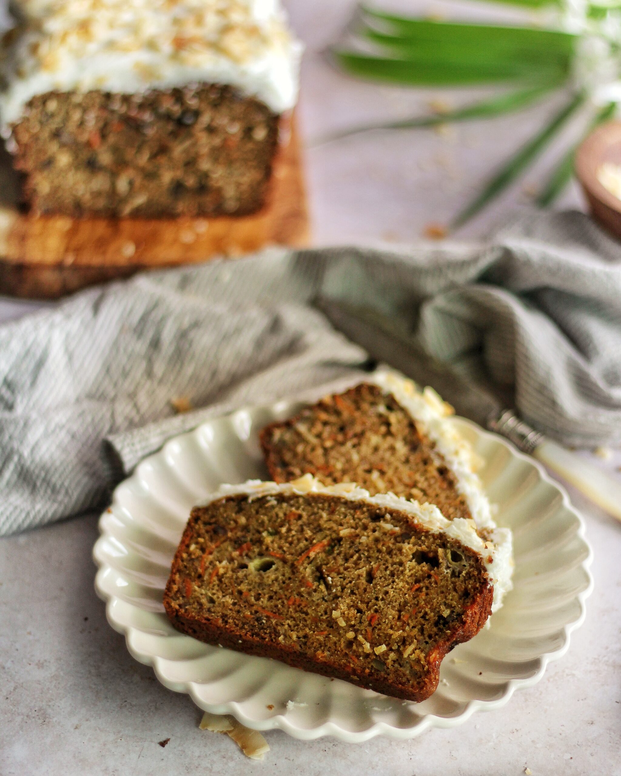 Two slices of coconut carrot cake on a plate